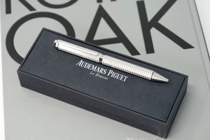 Audemars Piguet Royal Oak Pen with octagonal design, Tapisserie pattern engraving, silver-plated rhodium-coated twist cap, and AP logo engraving – luxury writing instrument.