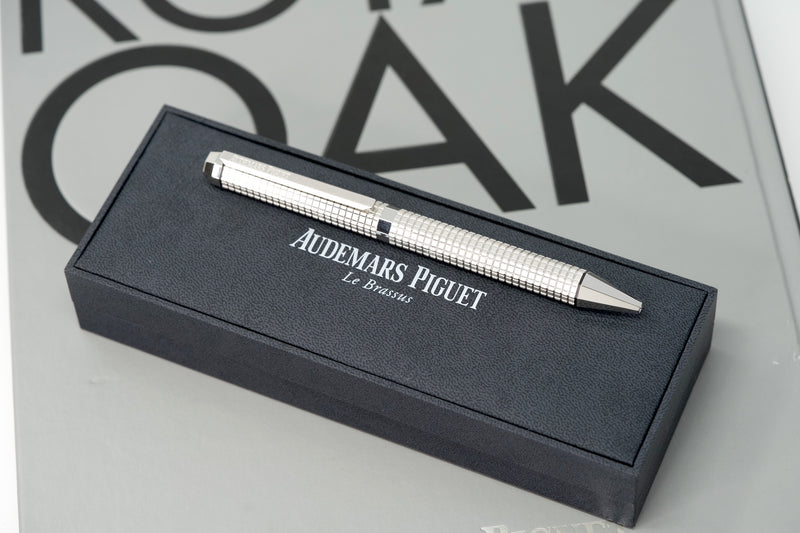 Audemars Piguet Royal Oak Pen with octagonal design, Tapisserie pattern engraving, silver-plated rhodium-coated twist cap, and AP logo engraving – luxury writing instrument.